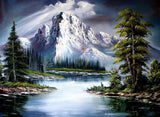 Snow-covered mountain peaks reflected in calm water