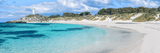 curving sandy shoreline beside clear blue water in sandy beach and shoreline